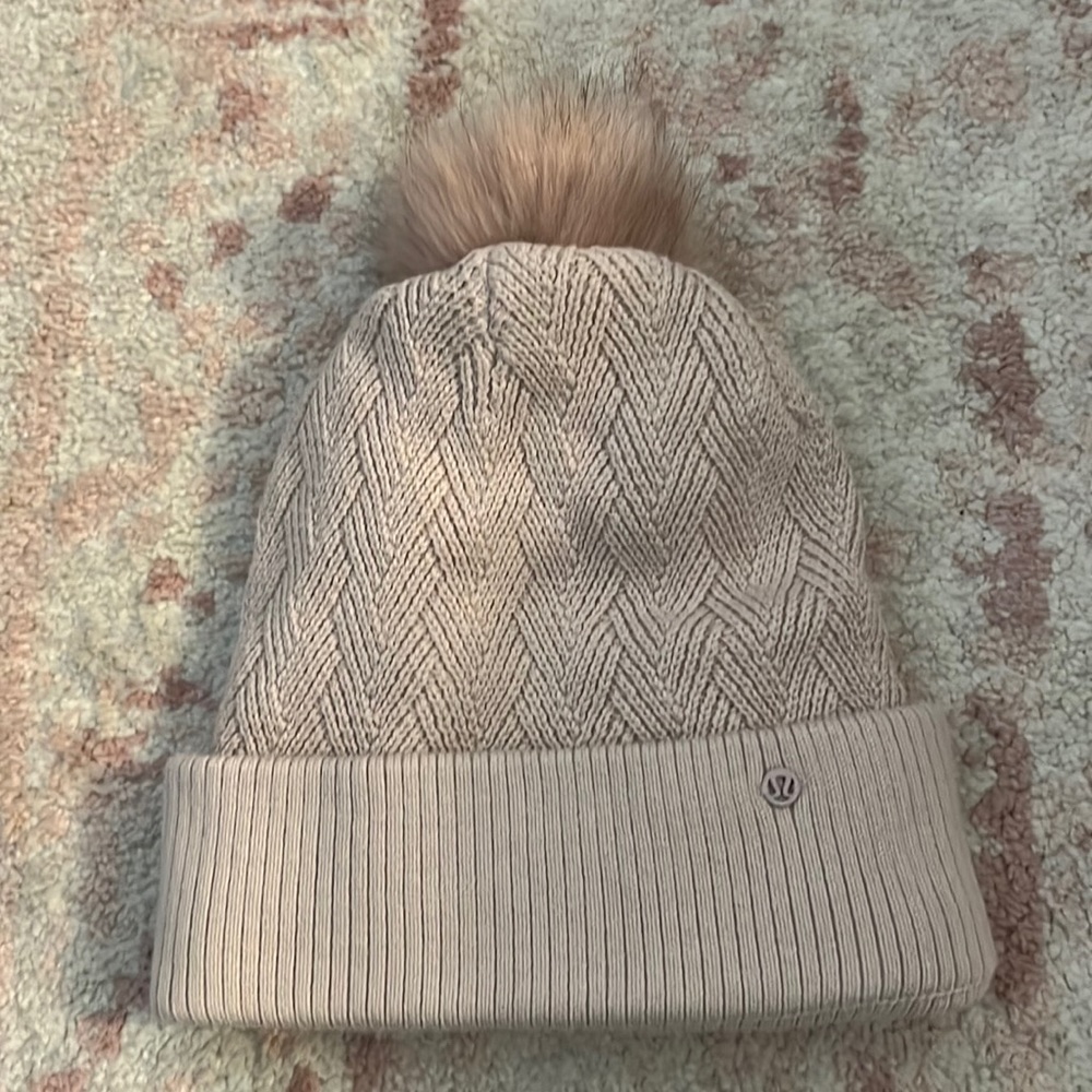 Light pink lululemon winter hat with Pom Pom